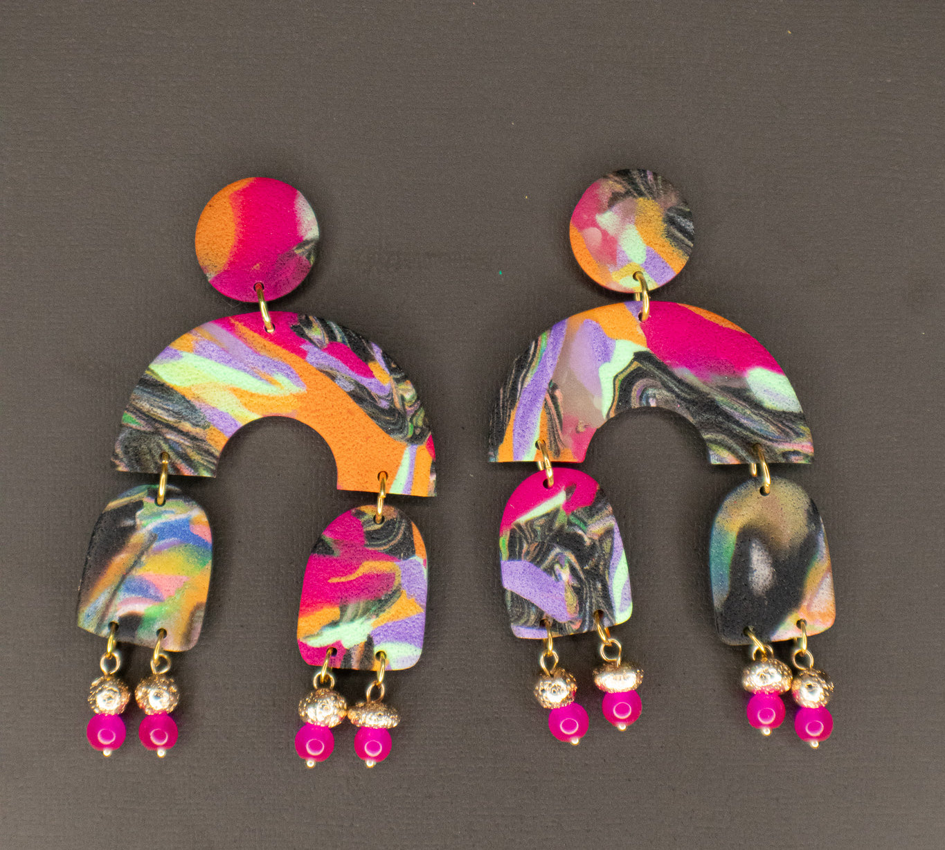 Colorful earrings with a pattern on a gray background