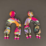 Colorful earrings with a pattern on a gray background