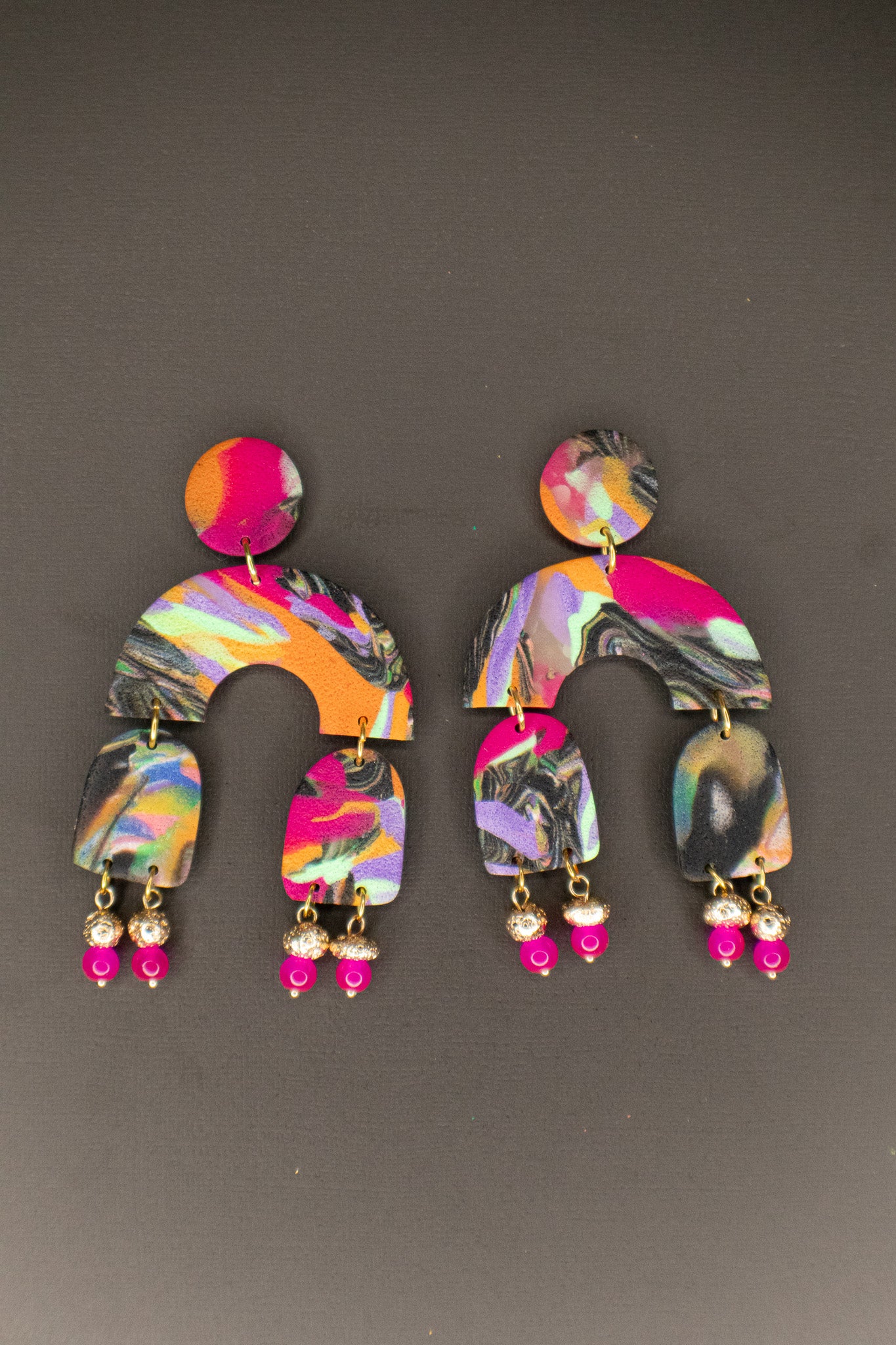 Colorful earrings with a pattern on a gray background